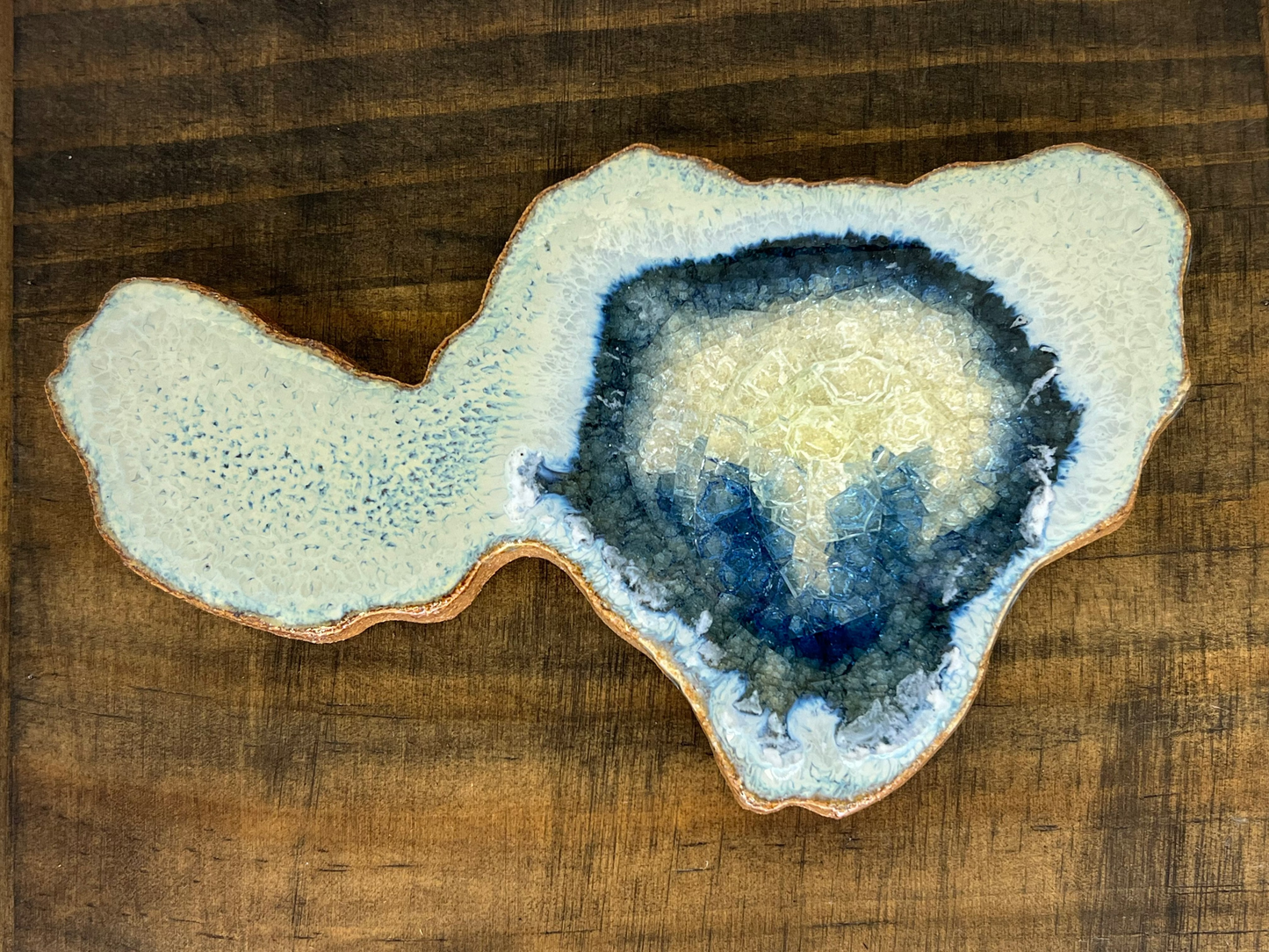 Geode-like ceramic piece on a wooden surface