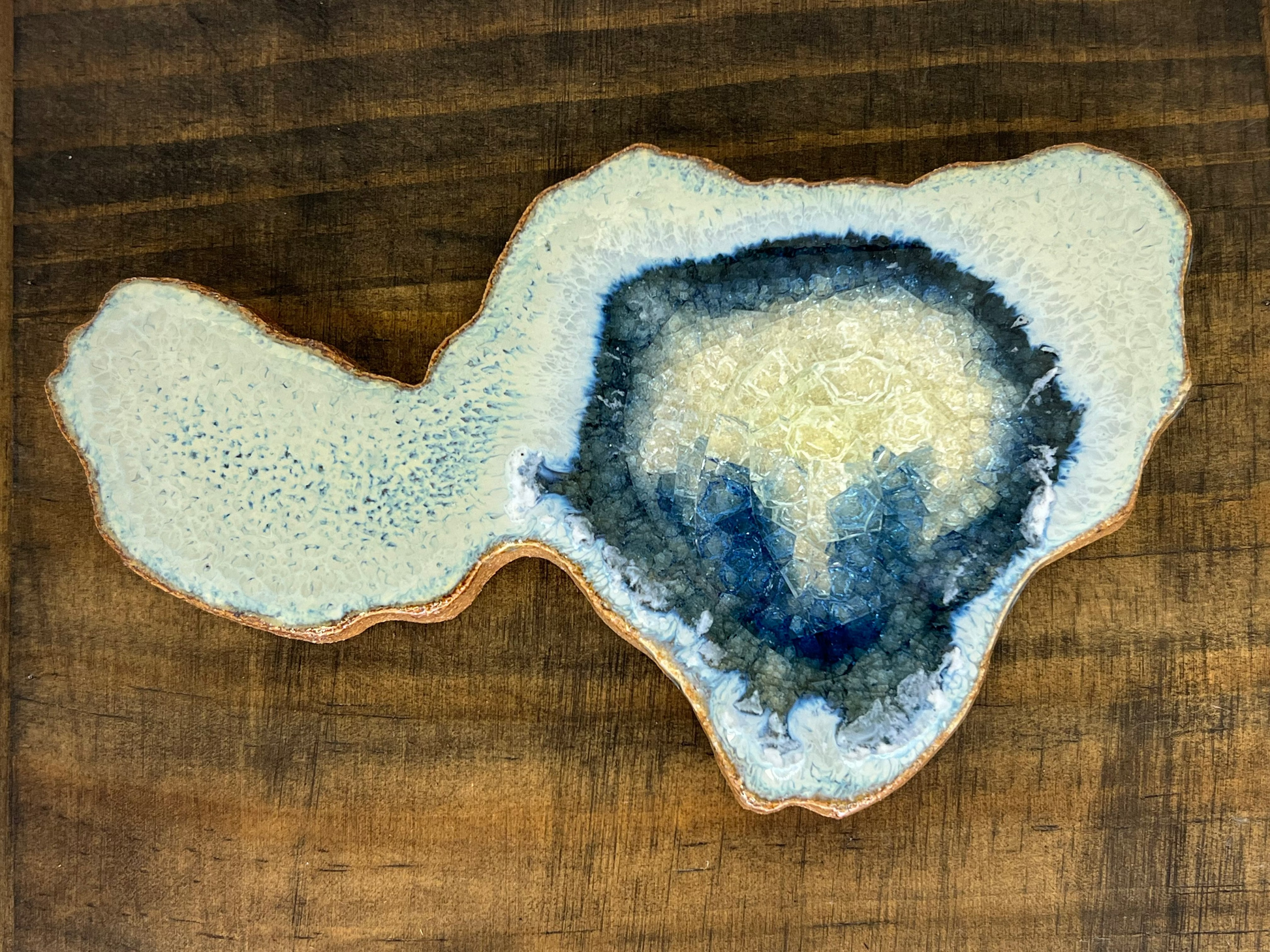 Geode-like ceramic piece on a wooden surface